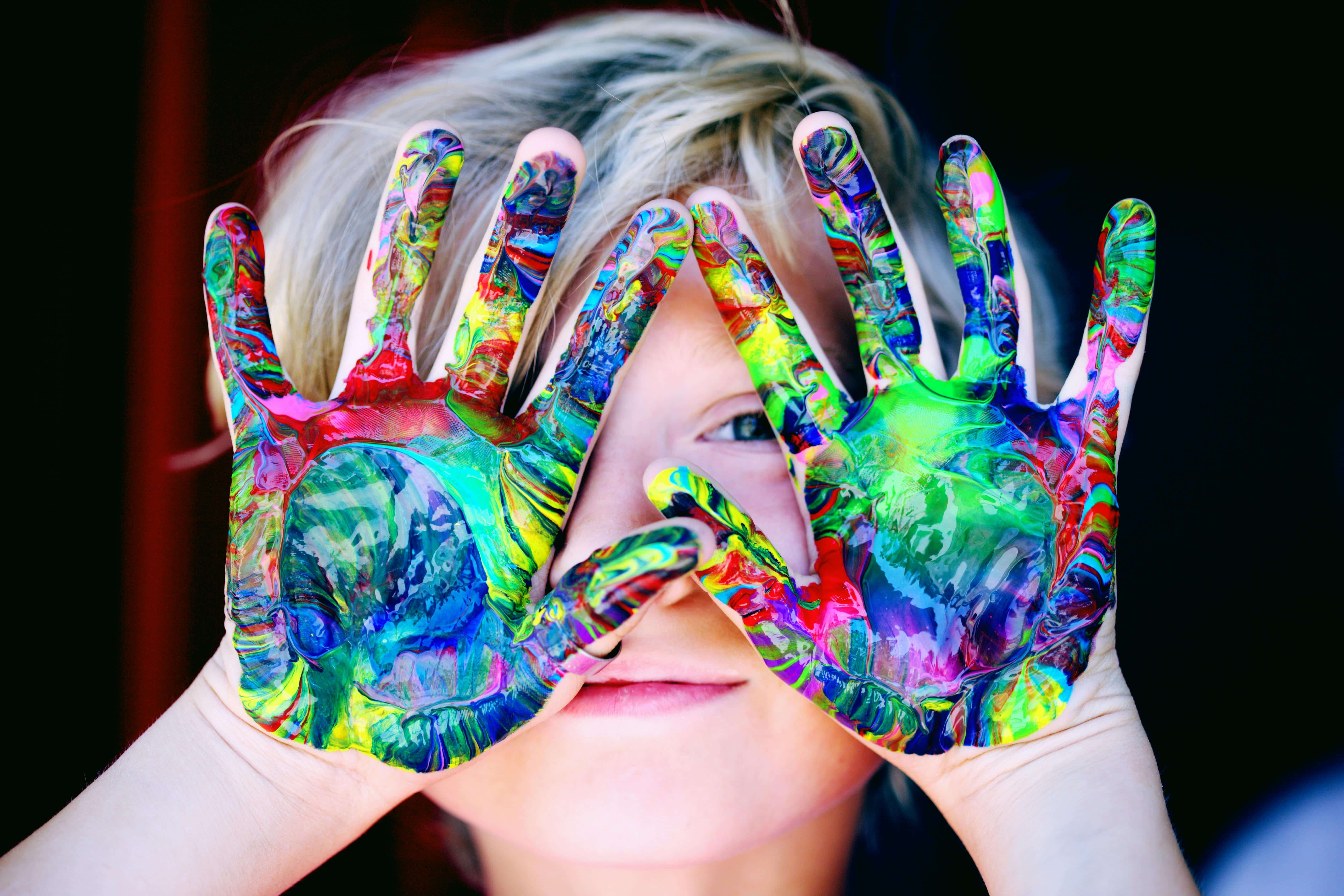 Child with colorful painted hands traveling with special needs kids
